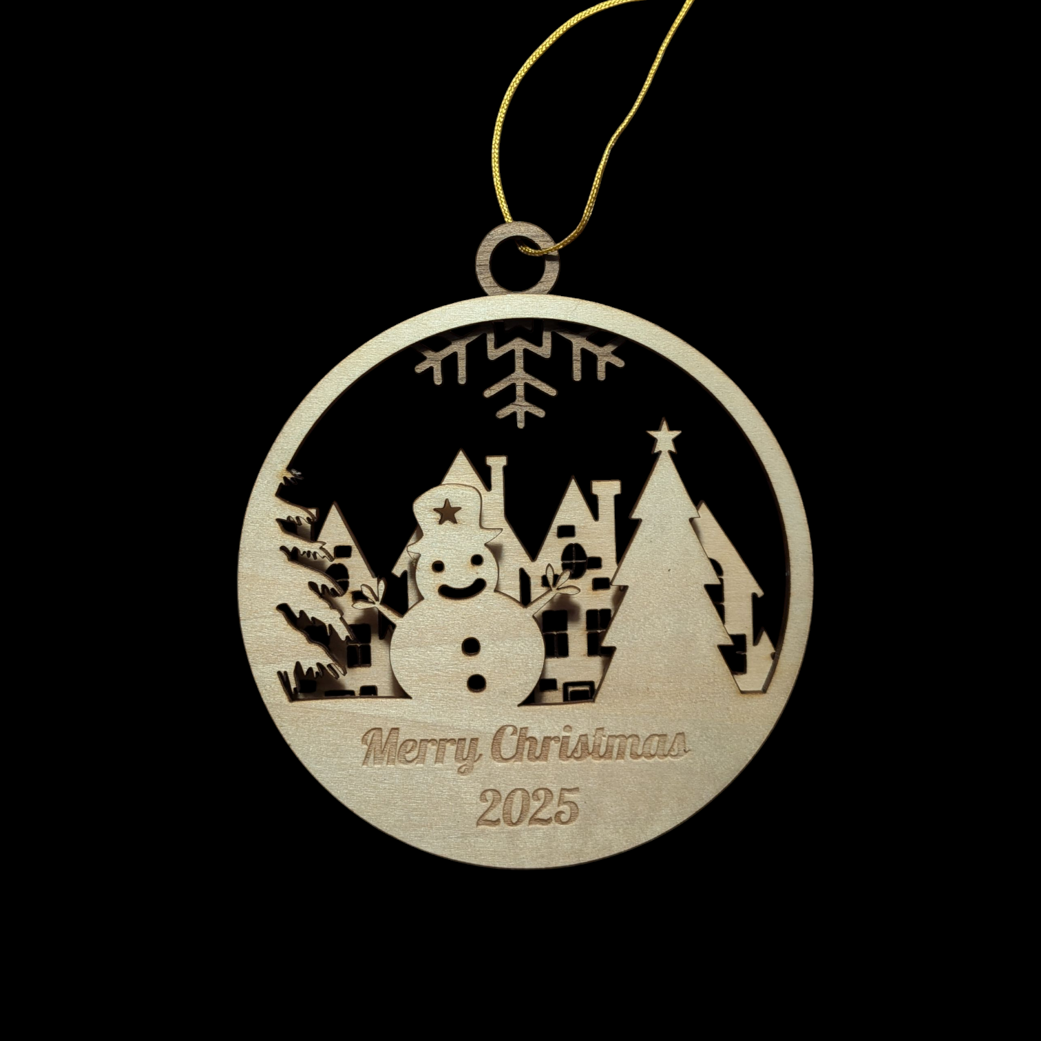 Wooden Christmas ornament with snowman and village design, featuring 'Merry Christmas 2025' text, on a black background.