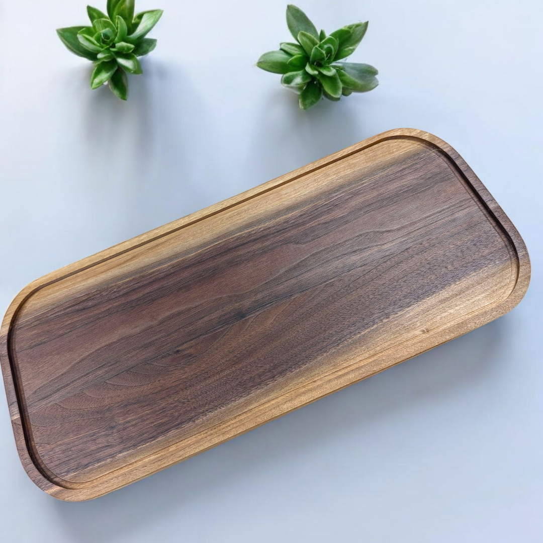 Handmade walnut serving tray with a natural finish on a light blue background
