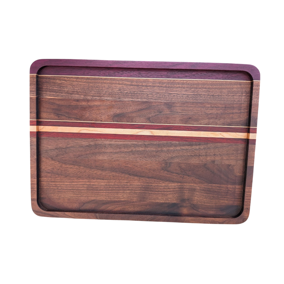 Hardwood cutting board with purple heart, maple & padauk exotic accents on a white background