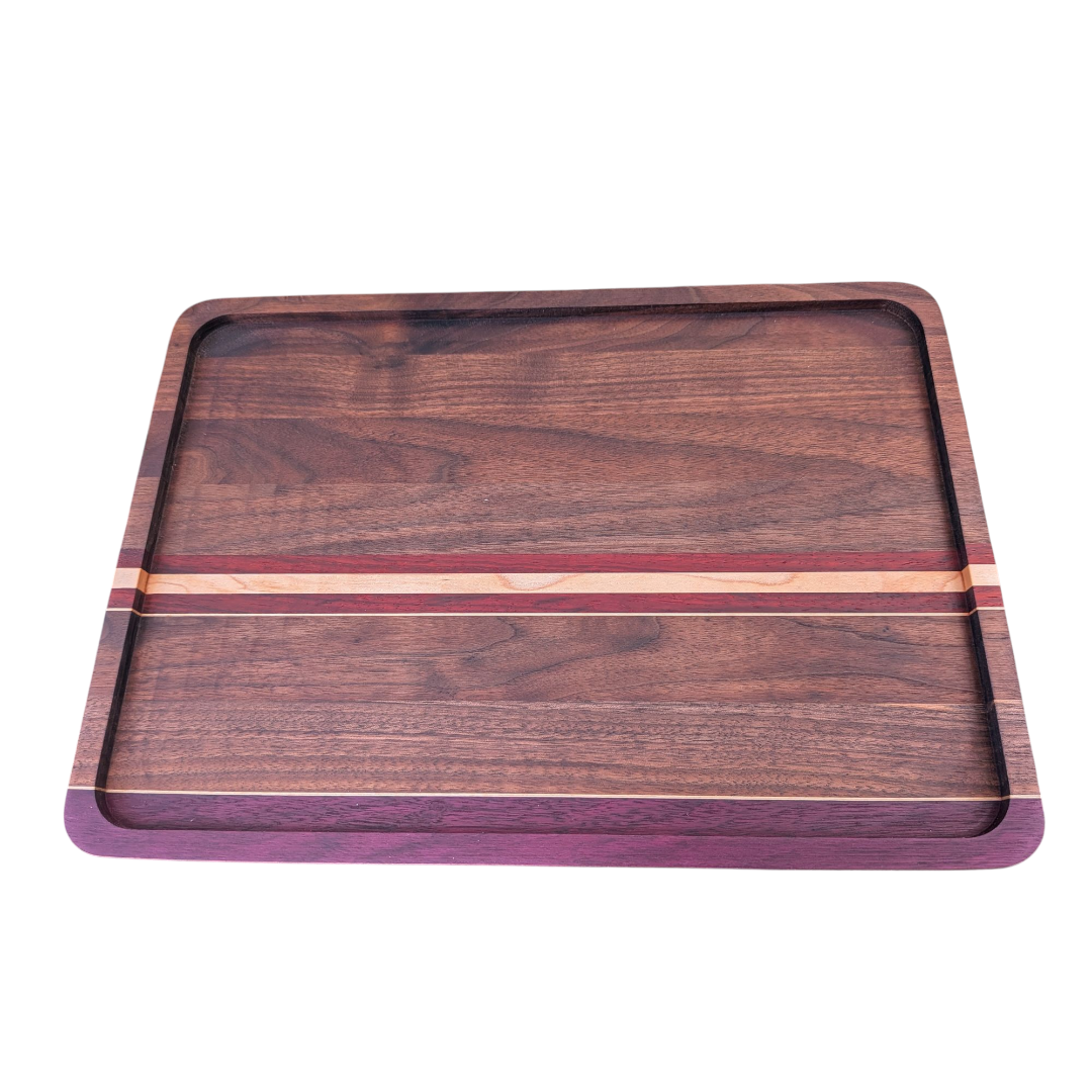 Hardwood Black walnut cutting board with exotic accent strips on a white background