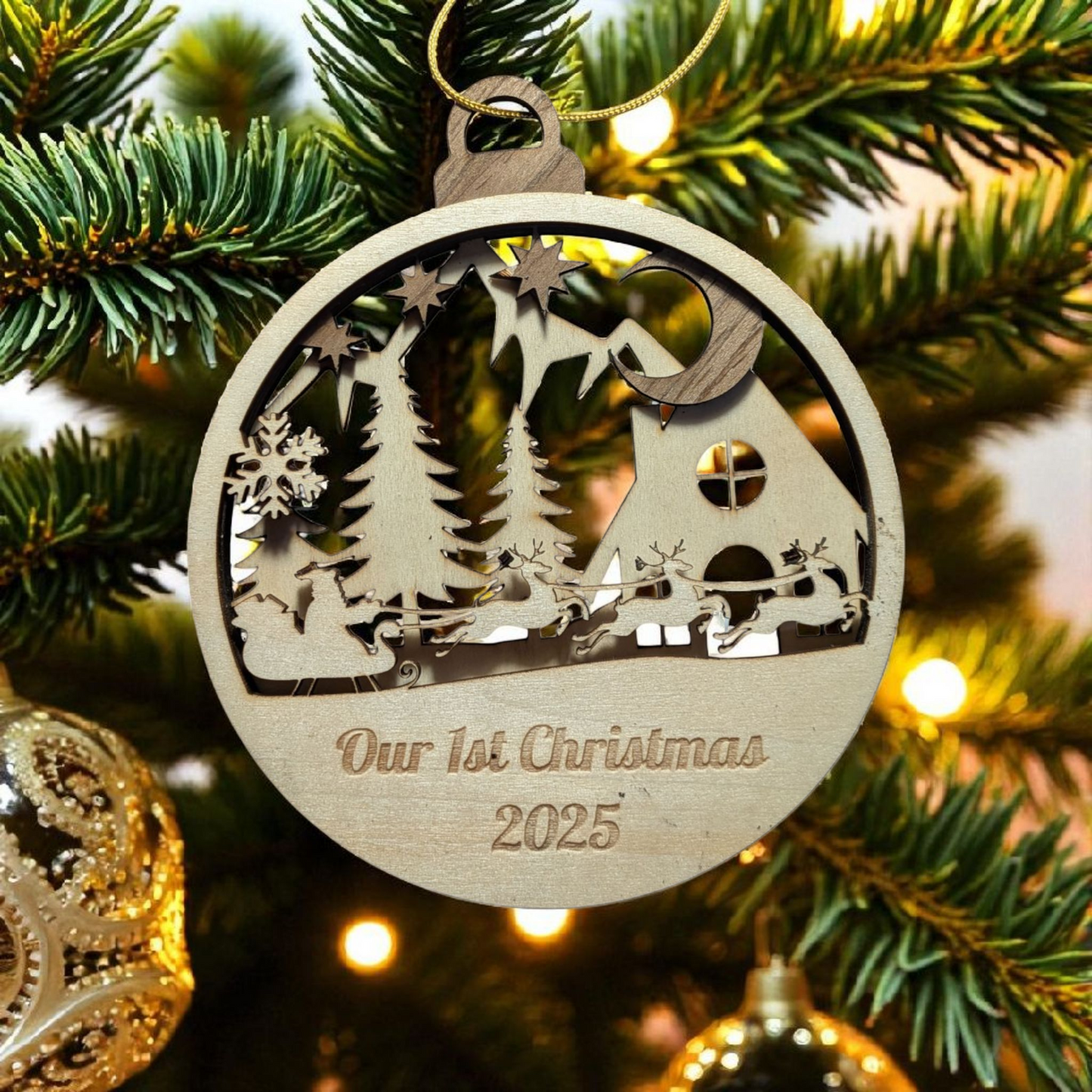 Wooden Christmas ornament with 'Our 1st Christmas 2025' on a decorated tree.