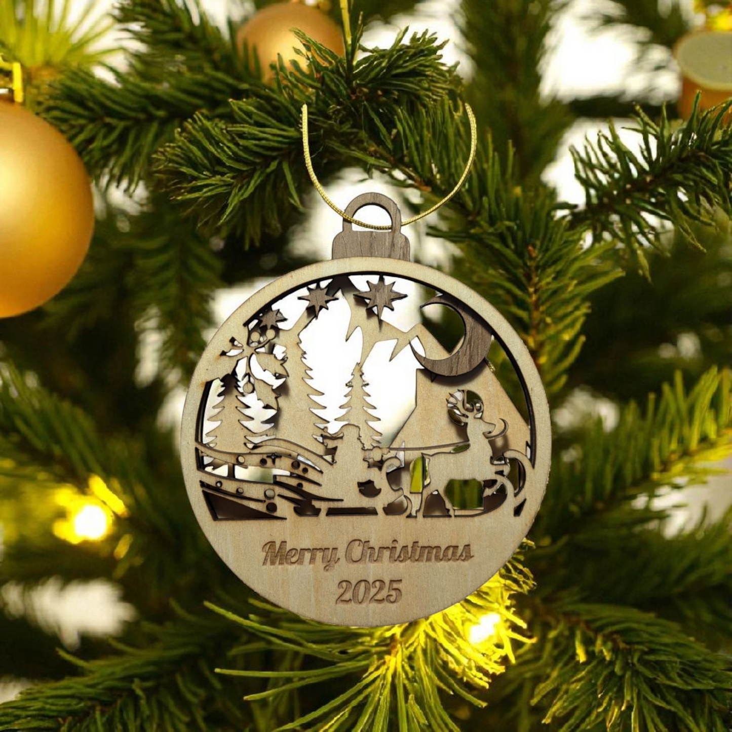 Wooden Christmas ornament with reindeer and trees on a decorated tree.