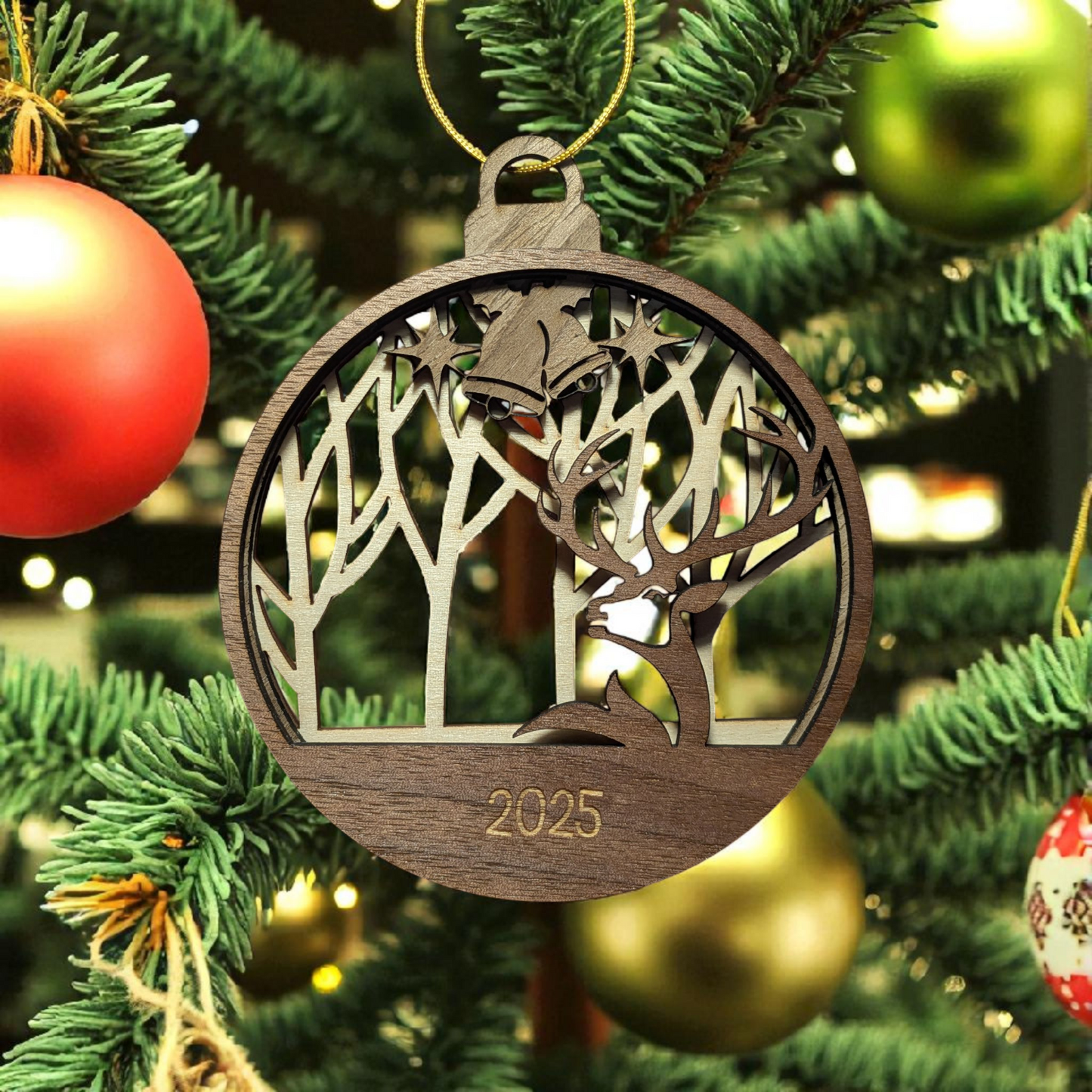 Wooden Christmas ornament with deer design and '2025' on a decorated tree.