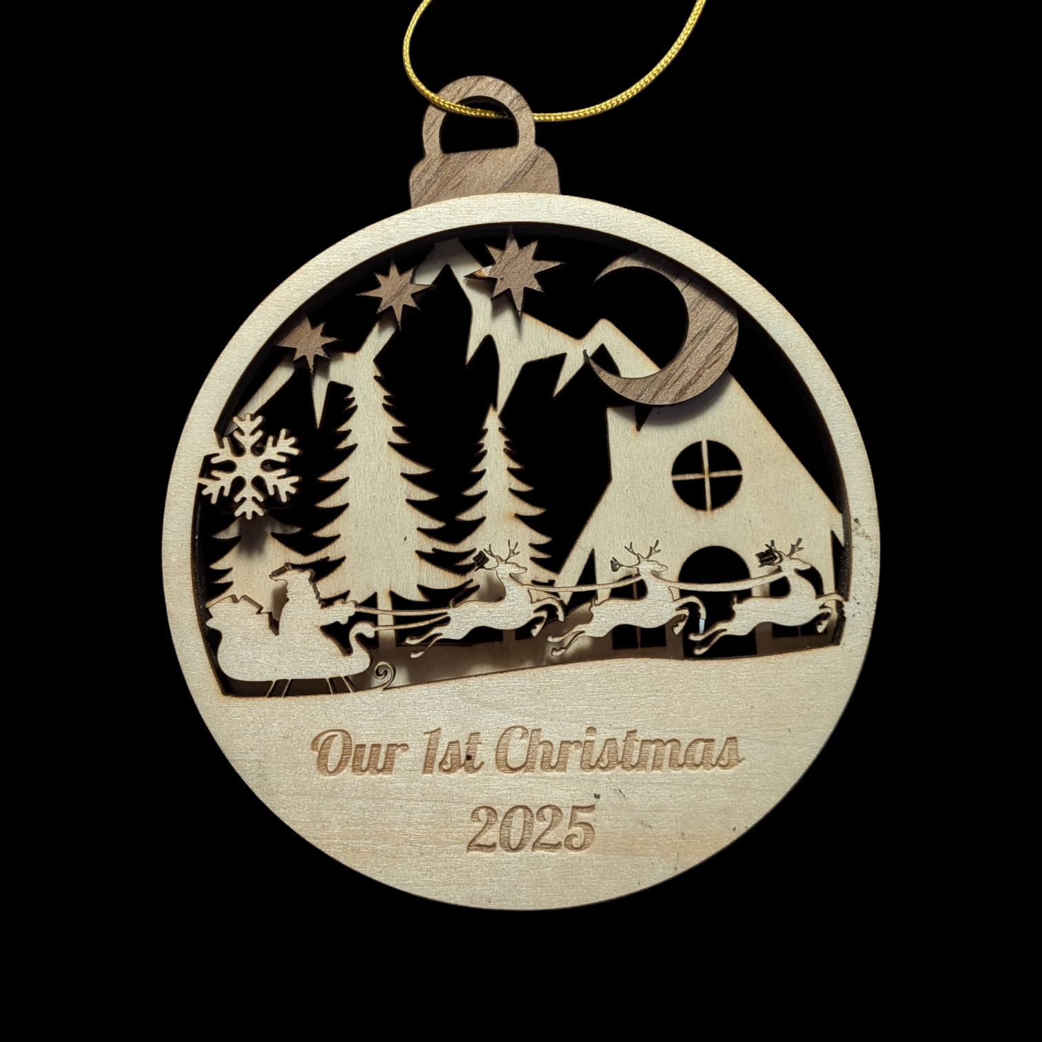Wooden Christmas ornament with 'Our 1st Christmas 2025' text on a black background