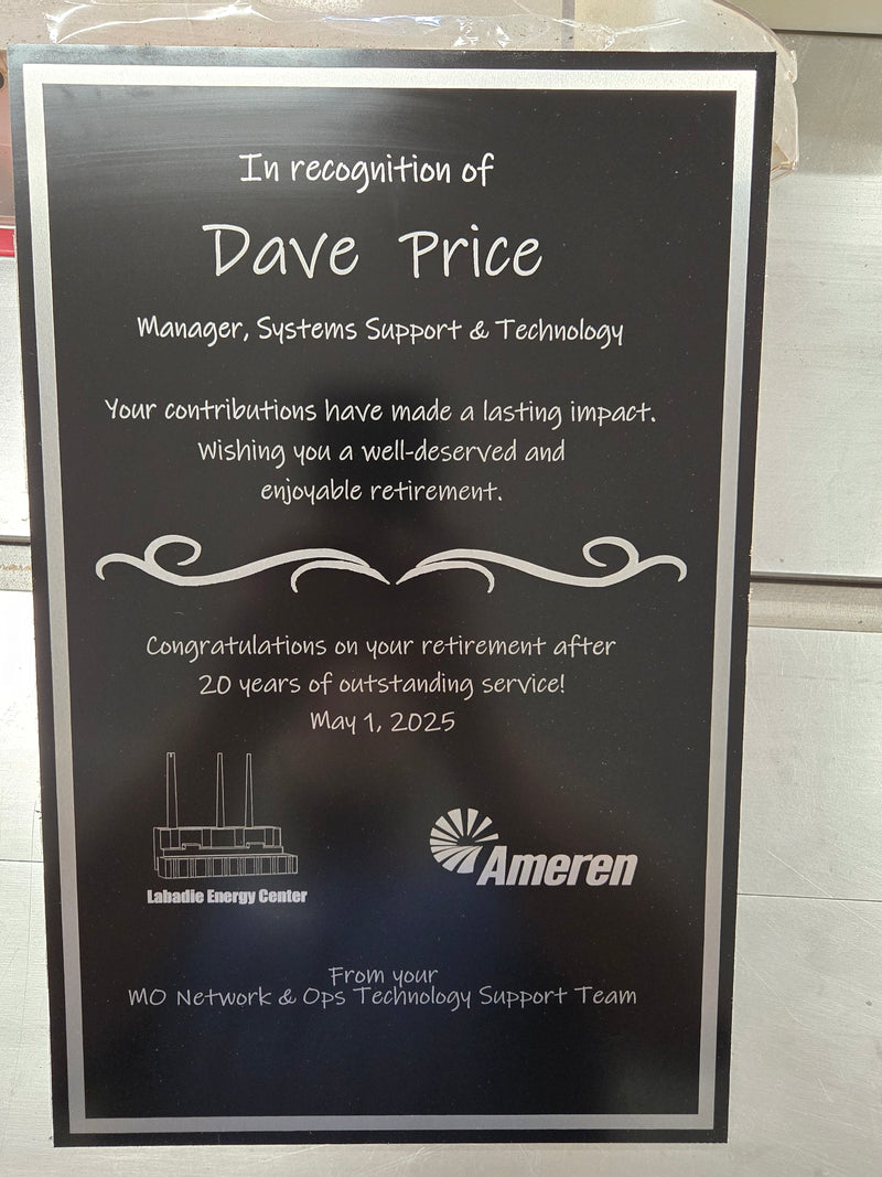 Black metal  retirement plaque with silver graphics  and corporate logo